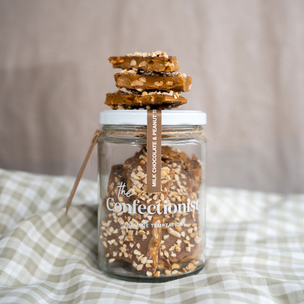 Milk Chocolate & Peanut Toffee stacked on top of a jar